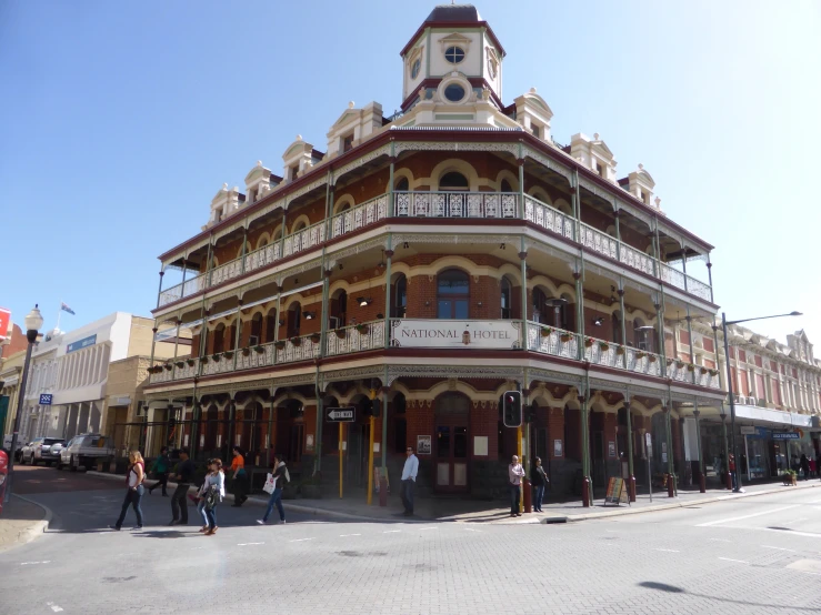 the people are walking in front of the old building