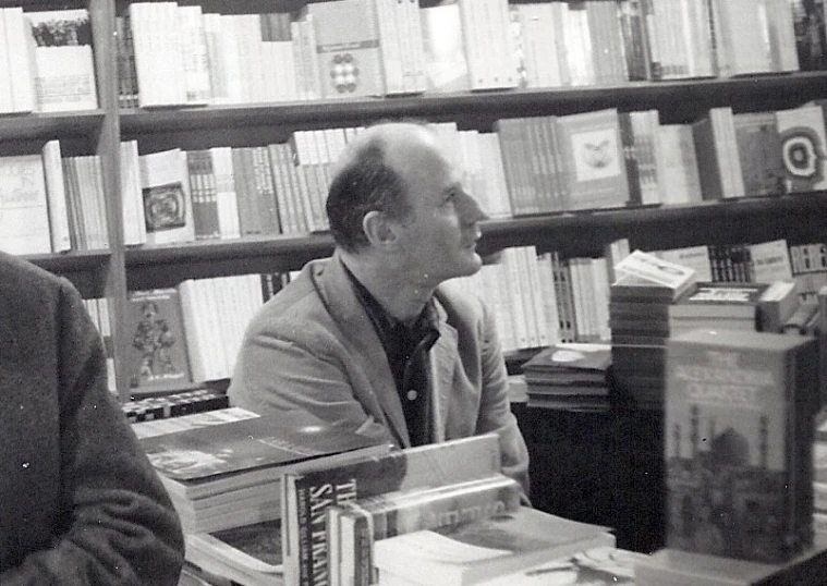 two men sitting in a liry near bookshelves