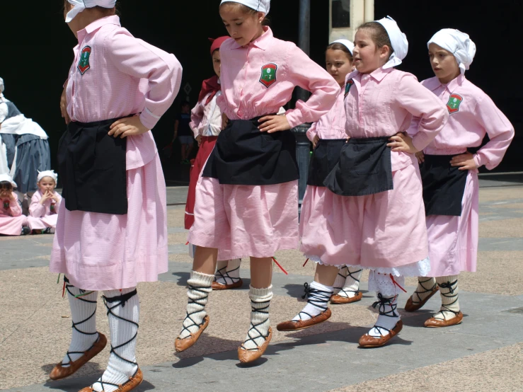 the girls are dressed in pink and black