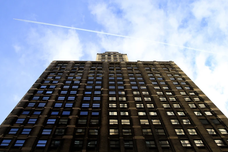 a tall building under a cloudy blue sky