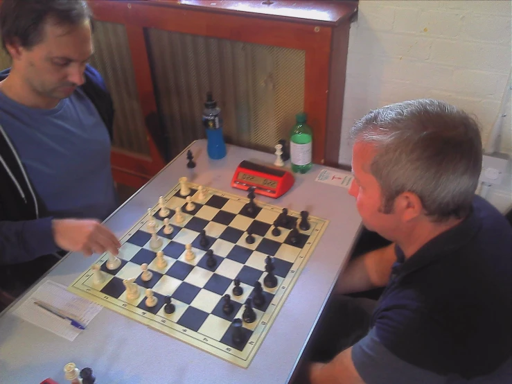 two men playing a game of chess together