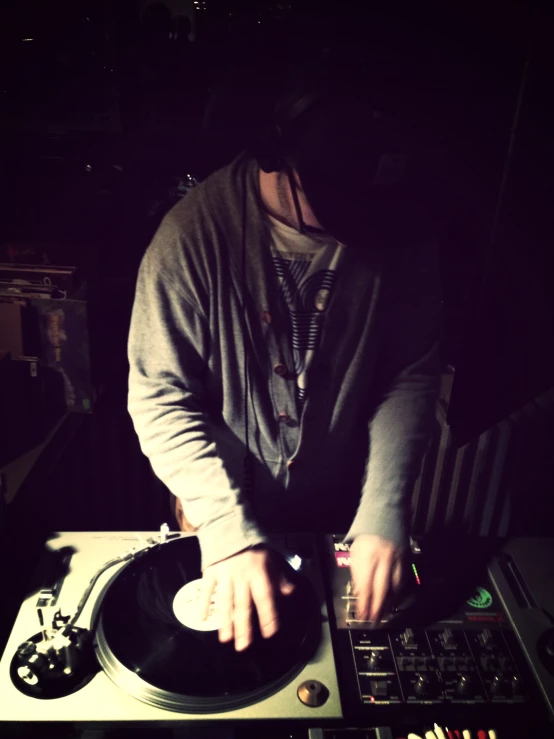 a man playing on the top of an old record player