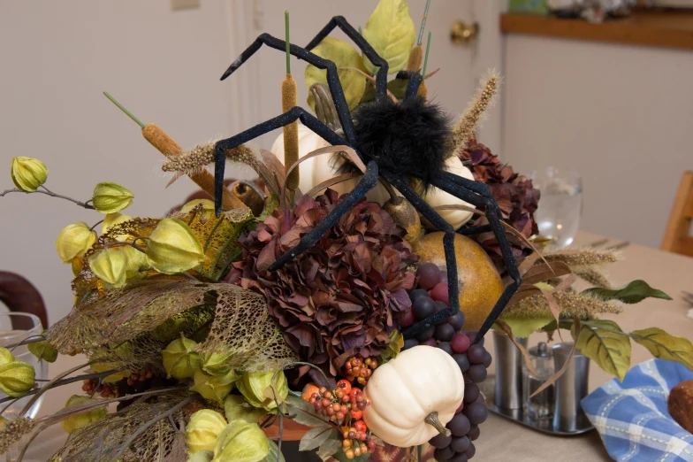 pumpkins, gs and other fall decorations are arranged on a table