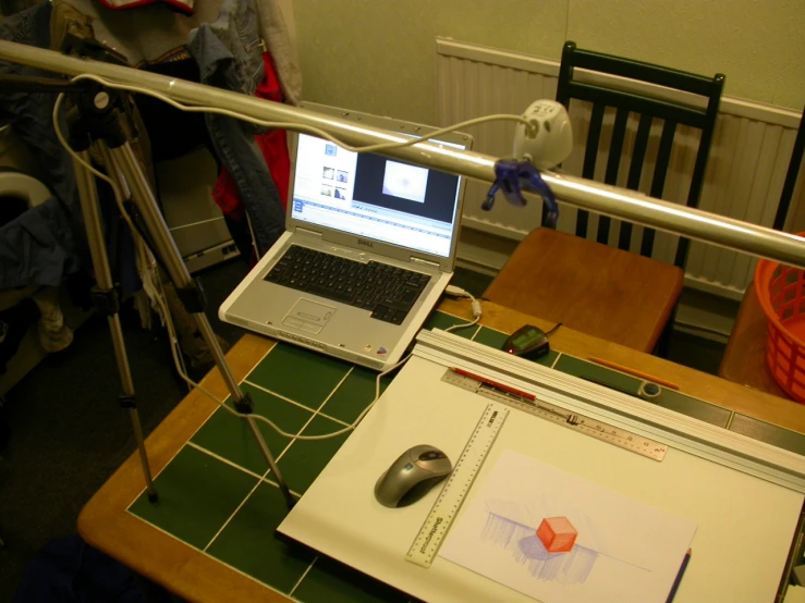 two lap tops and a computer on a desk