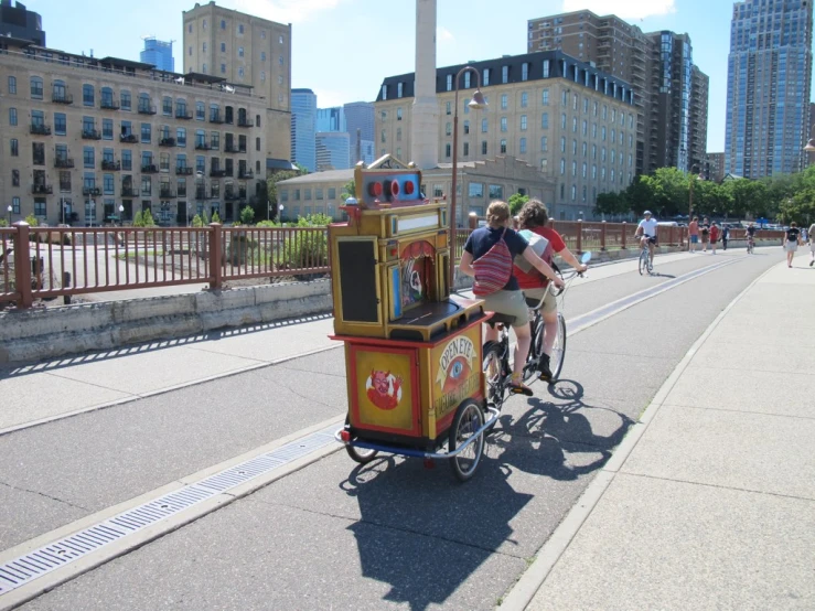 two people riding on the back of a bike next to a train cart