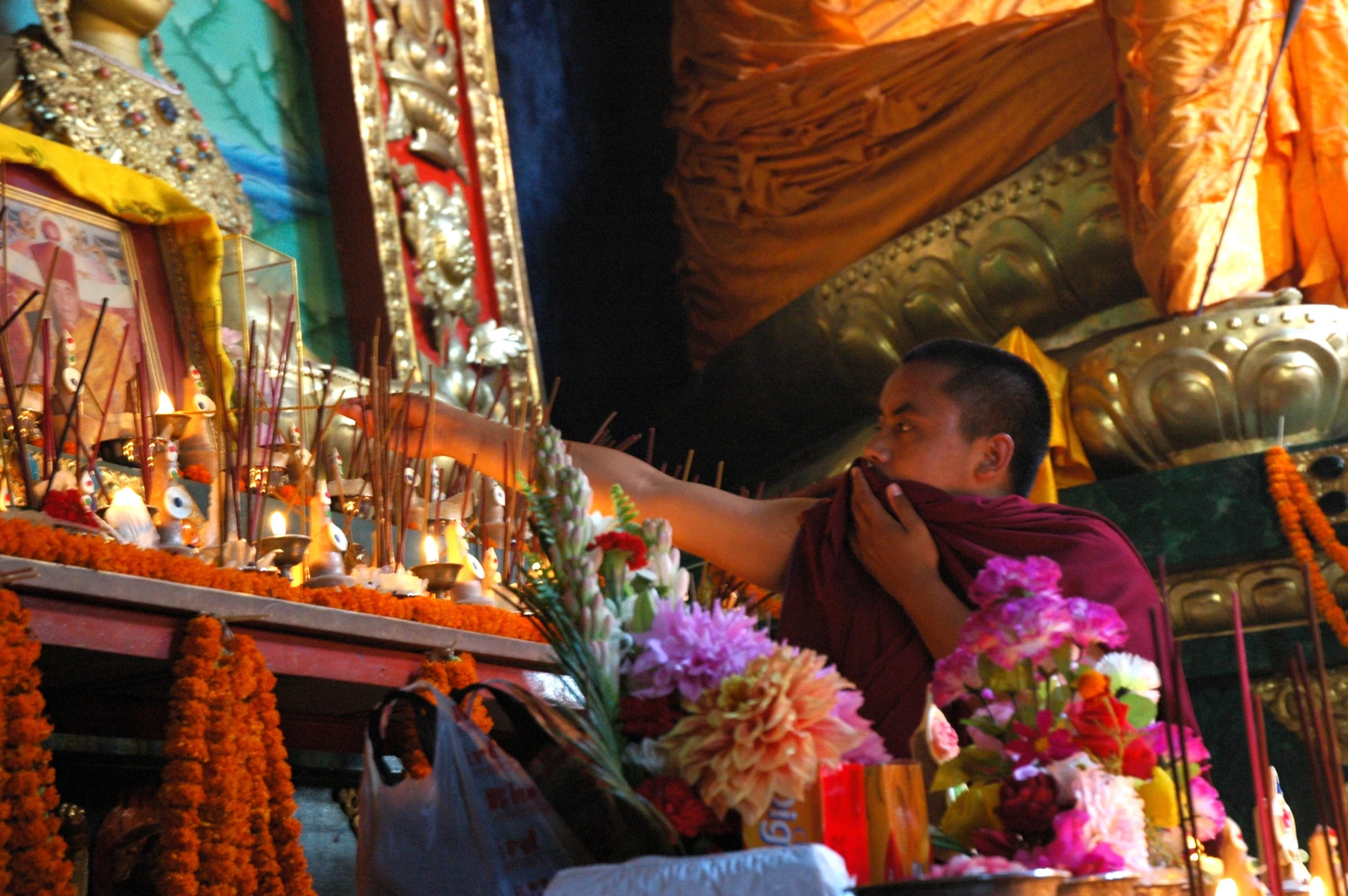 the monk is putting his hand out to the offerings