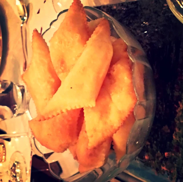 some food is in a glass bowl on a table