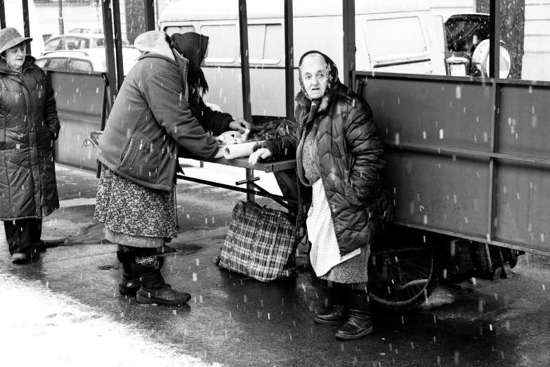 a black and white picture of people holding onto soing