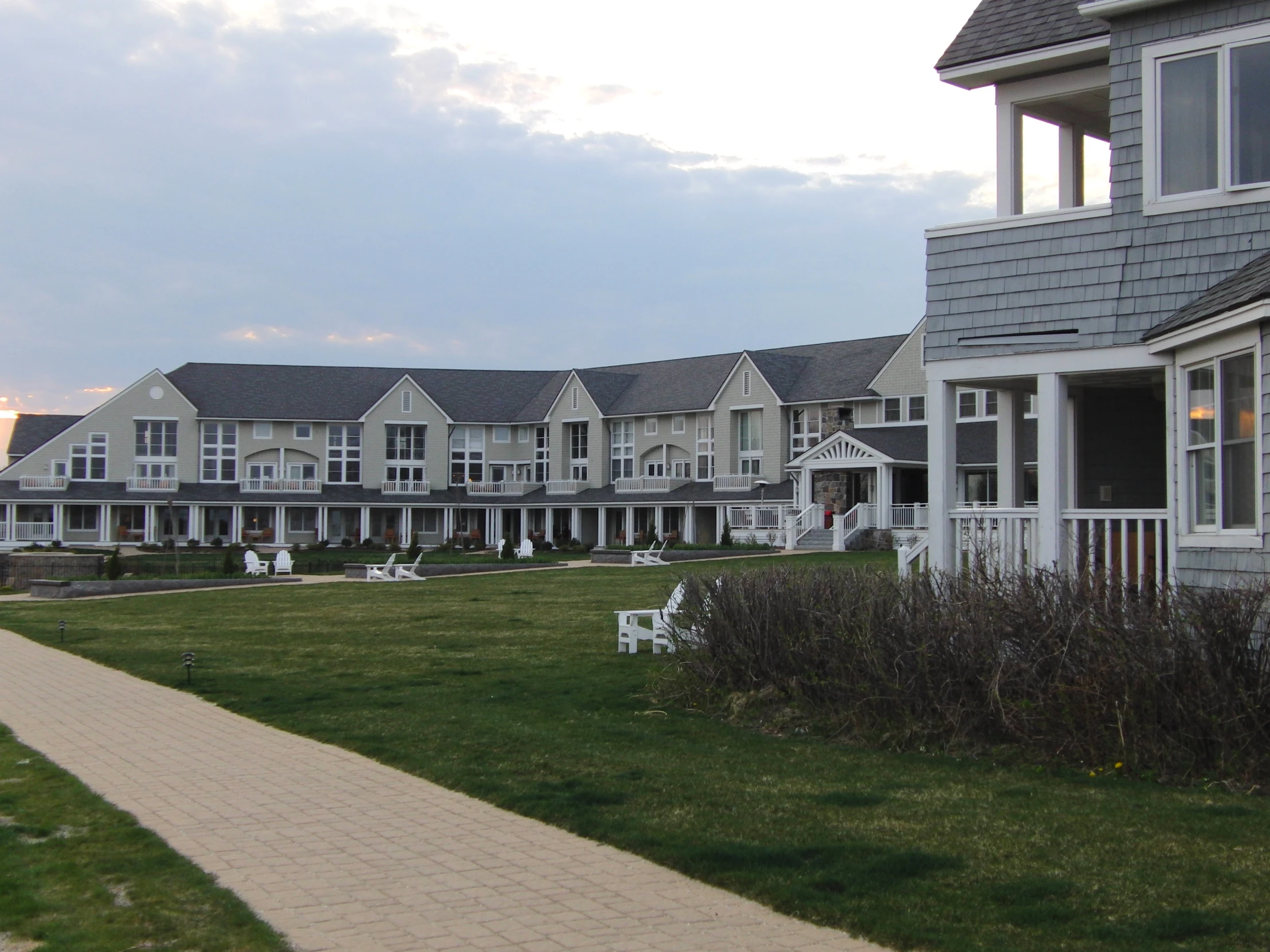 a row of white houses near a sidewalk