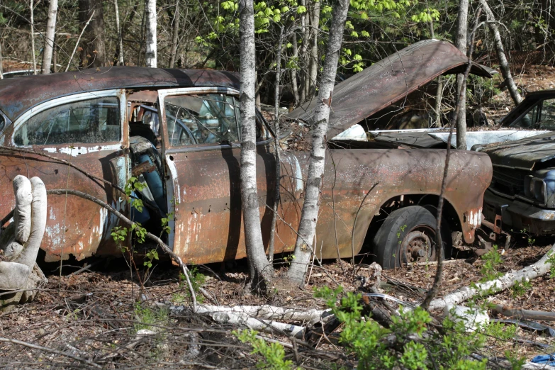 an old vehicle with no roof has been rusted