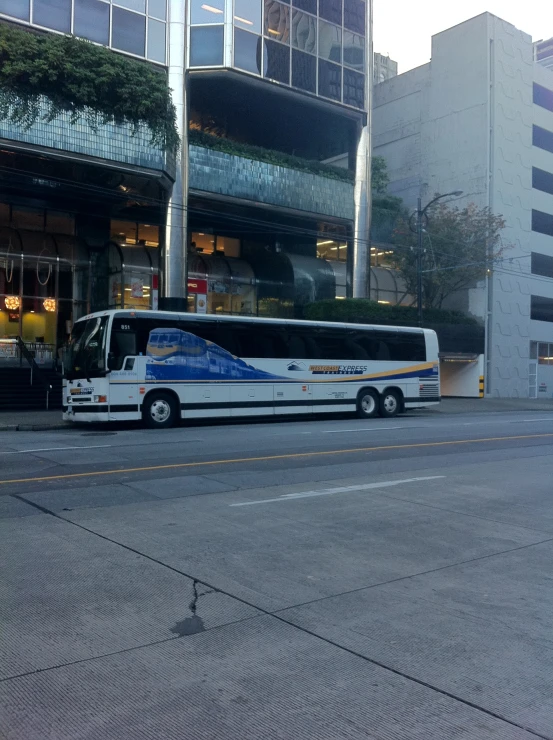 there is a city bus parked on the curb