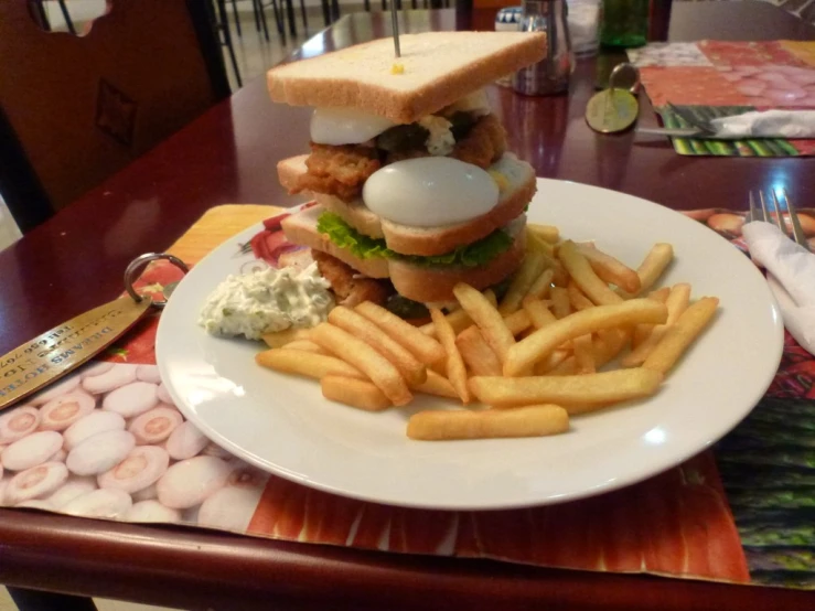 a close up of a plate of food with french fries