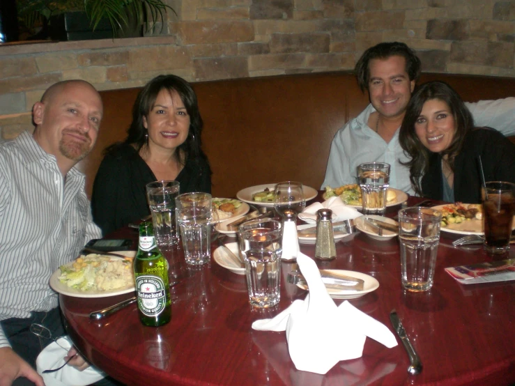 a family sitting down at a restaurant table for dinner