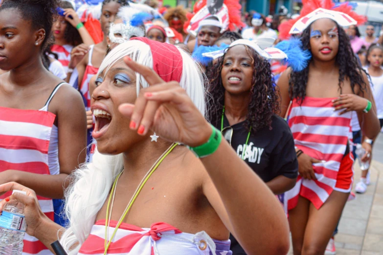 the woman is pointing to a crowd of other people