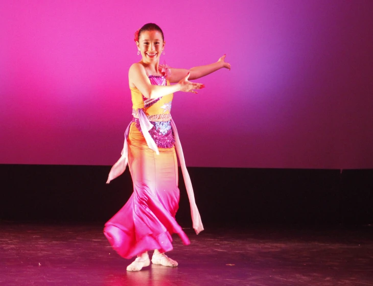 young female dancer in oriental style dress during performance