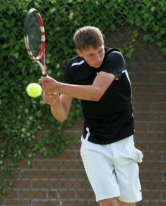 a tennis player gets ready to hit the ball