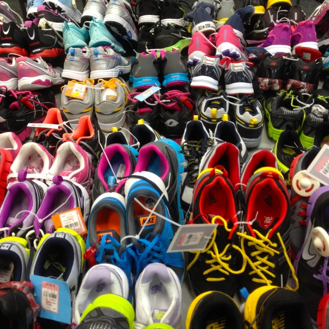 a market stall full of a variety of shoes and slippers