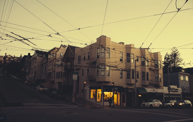 electric wires on top of a building and a street with cars