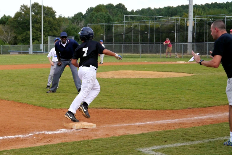 a baseball game in progress with the ball being thrown to the batter