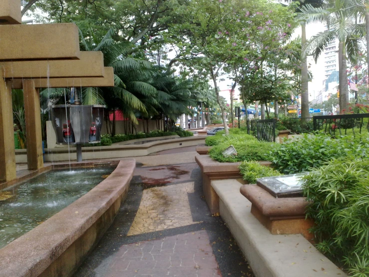 the empty city side walk is lined with fountains