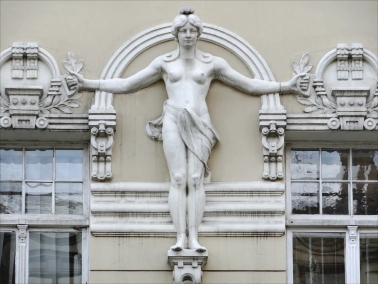 an elaborate statue of a man on the side of a building
