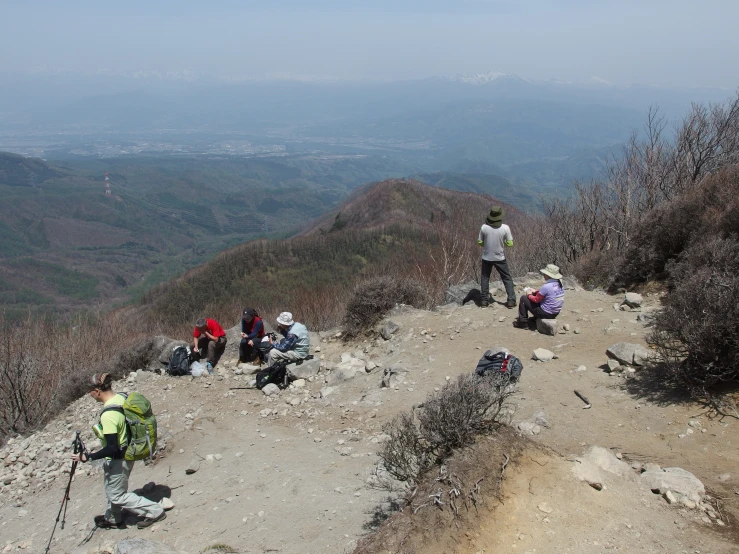 people on top of a rocky, arid mountain with backpacks