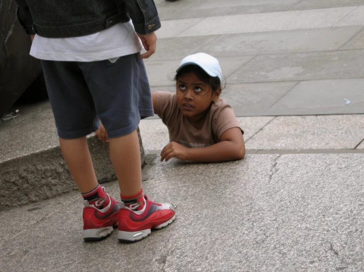 a  laying down with a skateboard on his head