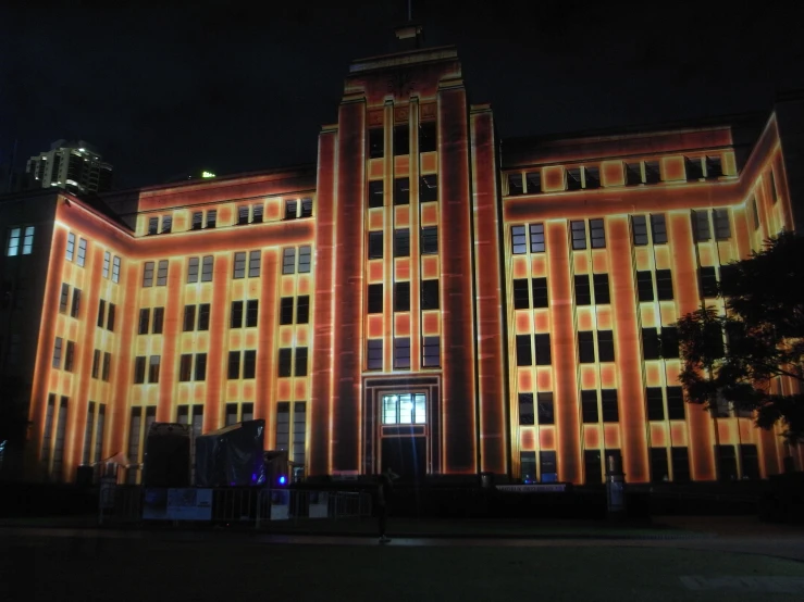 building with orange color at night time in urban area