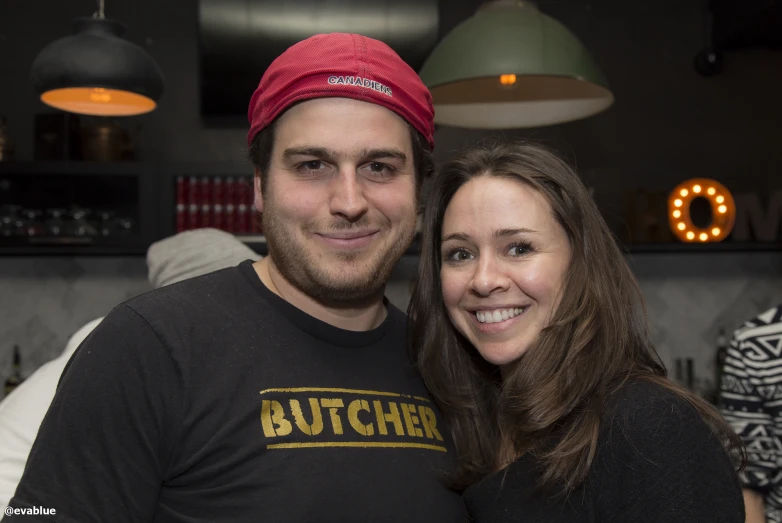 a young couple poses together at an event