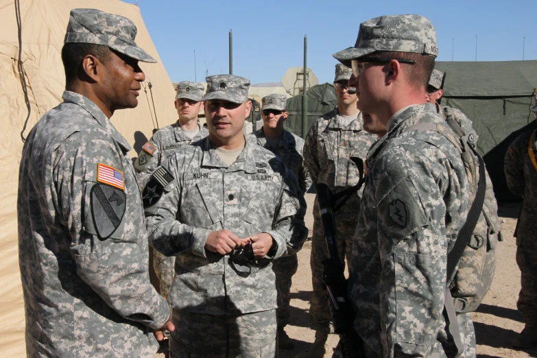 a group of soldiers greeting each other with a smile