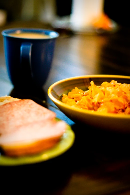 a bowl of food and bread on a table