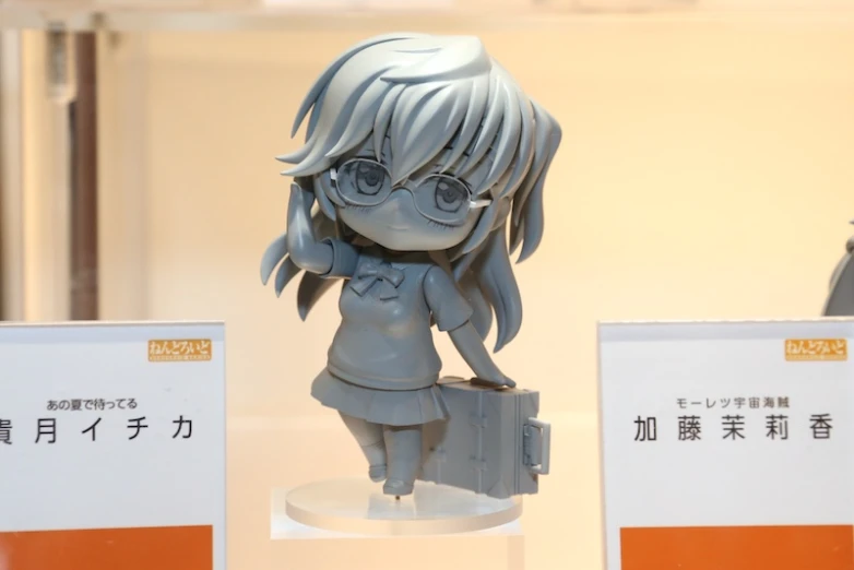 a close up of a small figure on display near two packages