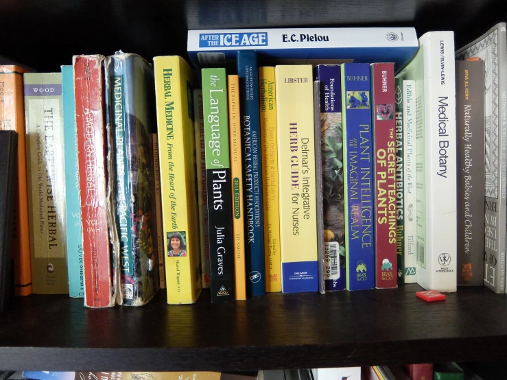 a shelf filled with many different types of books