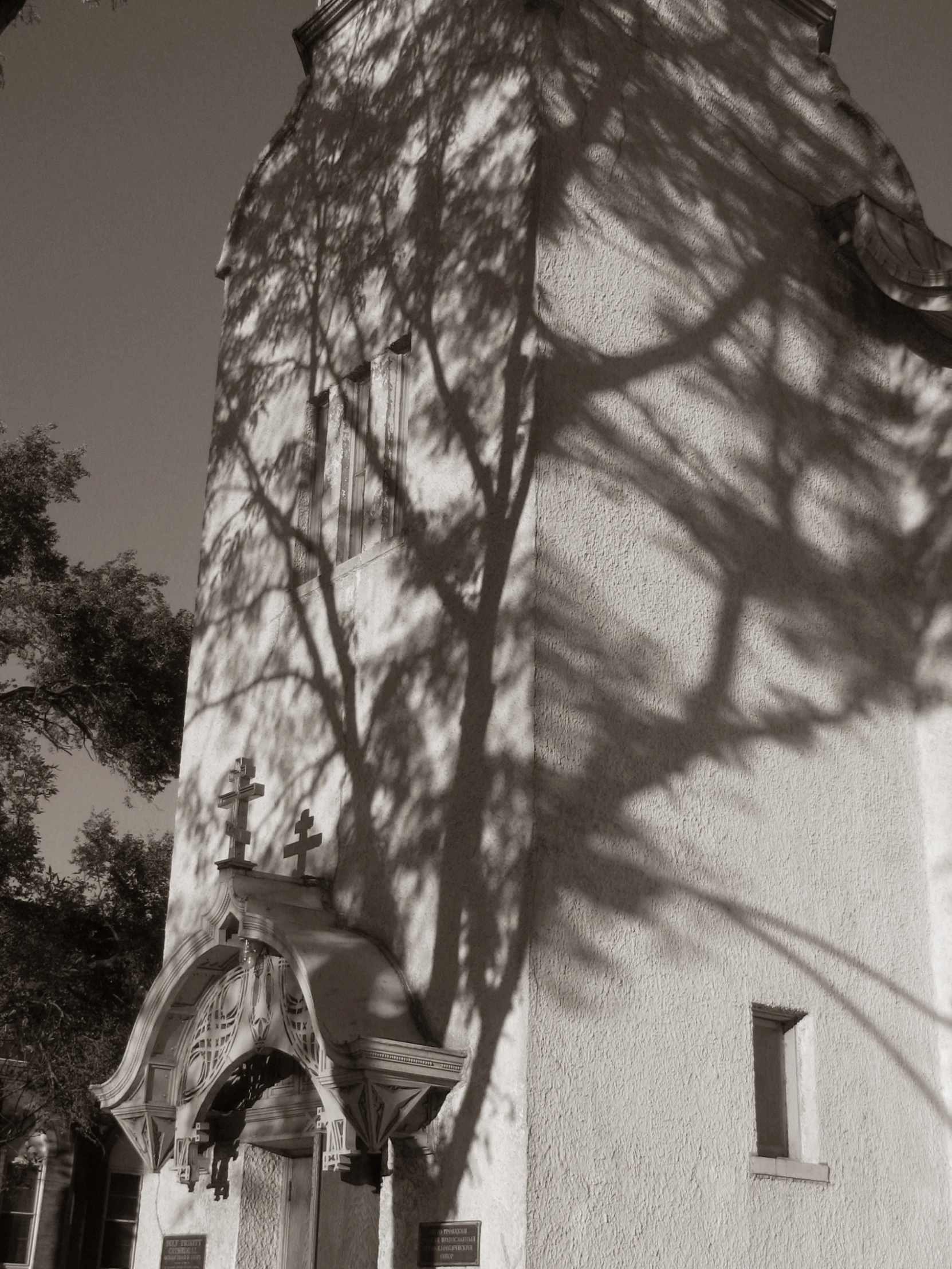 shadow of a building that has a clock on it