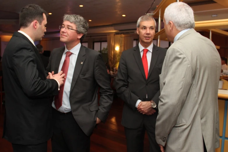 there are men in suits and ties standing together