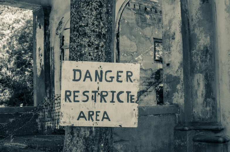 a sign on a pole reads danger restricted area