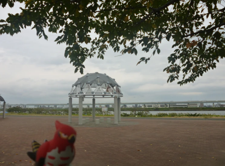 the bench is located on a sandy area near water