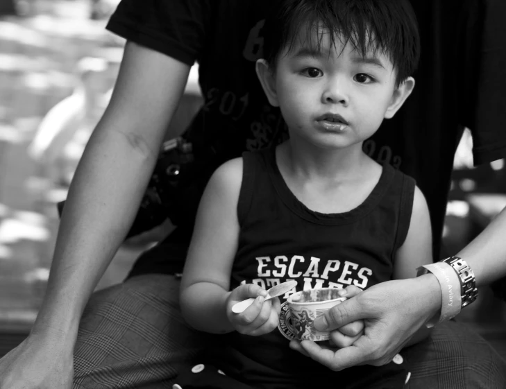 a young child sitting on the lap of a woman