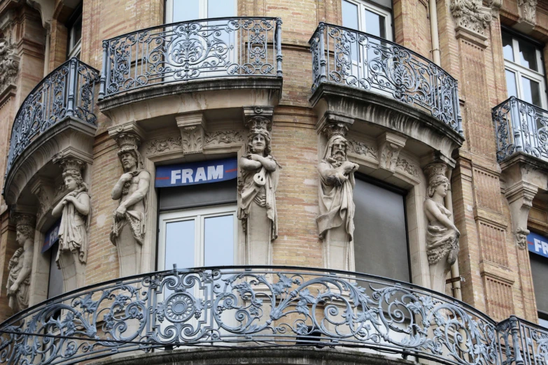 some statues on the balcony of a building