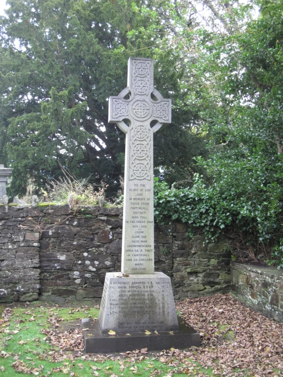 a big nice and fancy stone cross in the grass