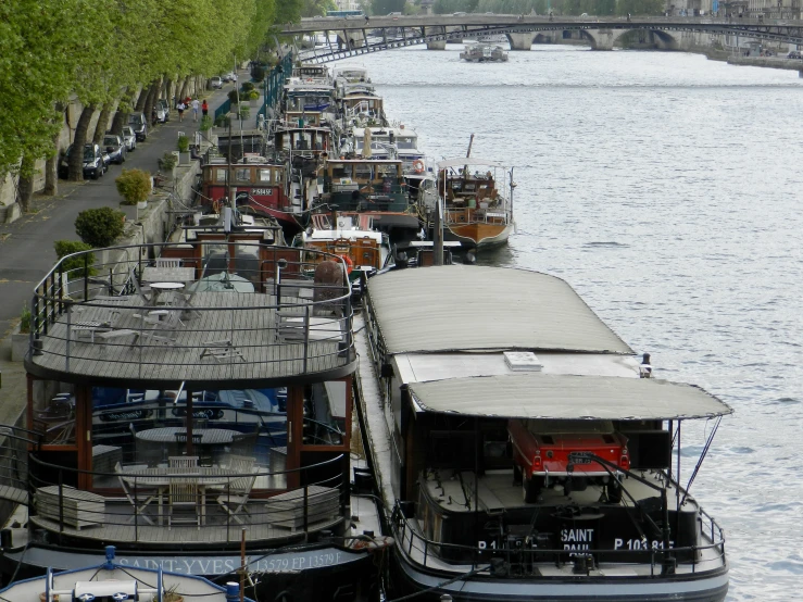 several boats are docked along the river side