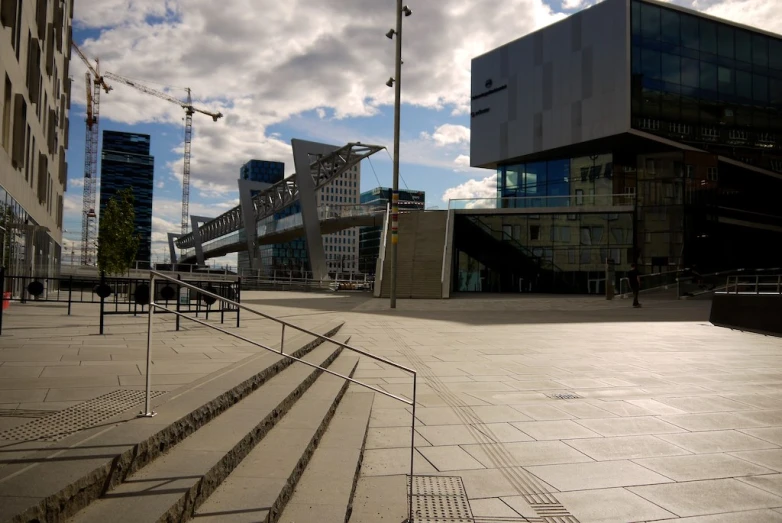 a square with some stairs to the side and a building in background