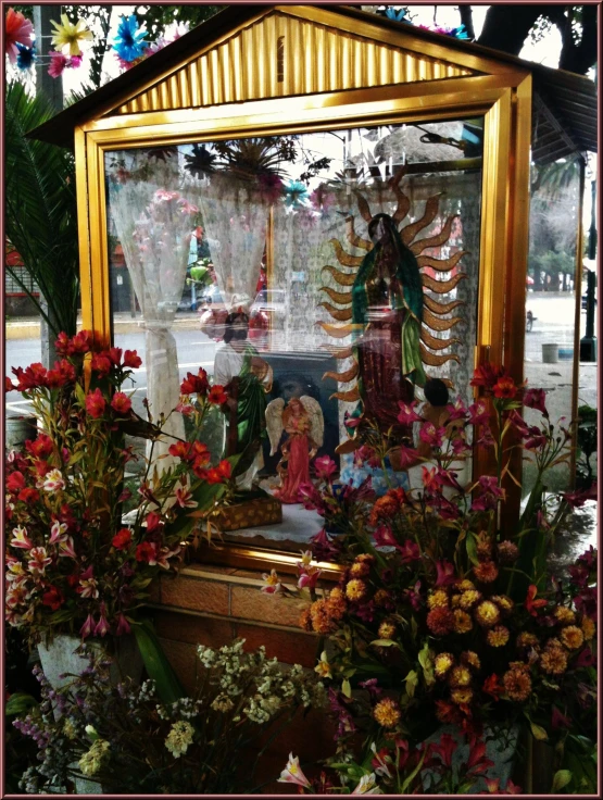 an altar in the window with flowers all around