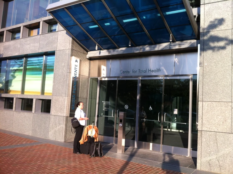 a man with a bag walking past a building