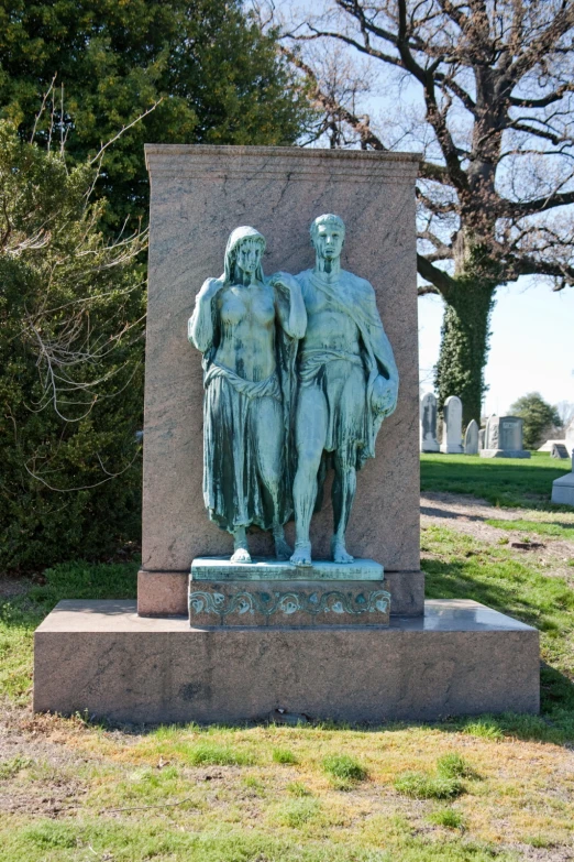 a statue of a man and a woman stands in the foreground