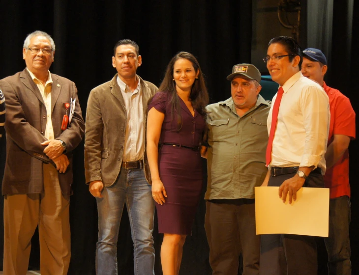 several people in business attire and two women in a business suit pose for the camera