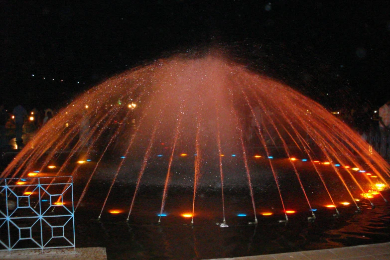 the city fountain has lights and is brightly colored