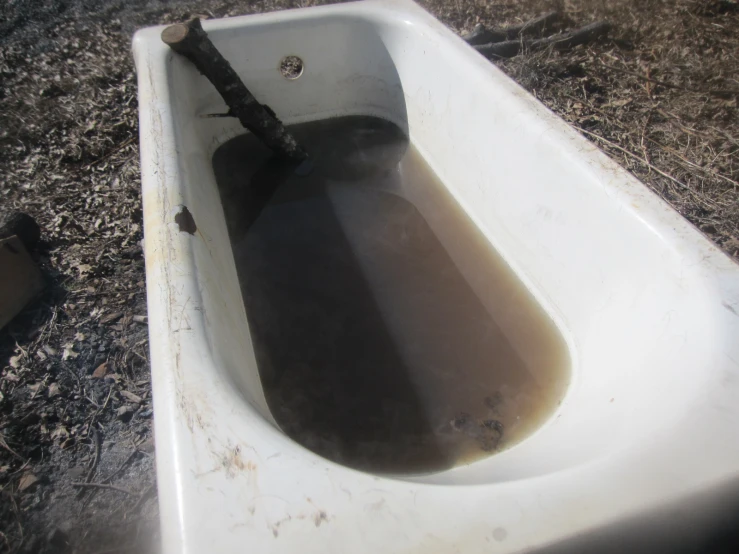 a long tube filled with water in a sink