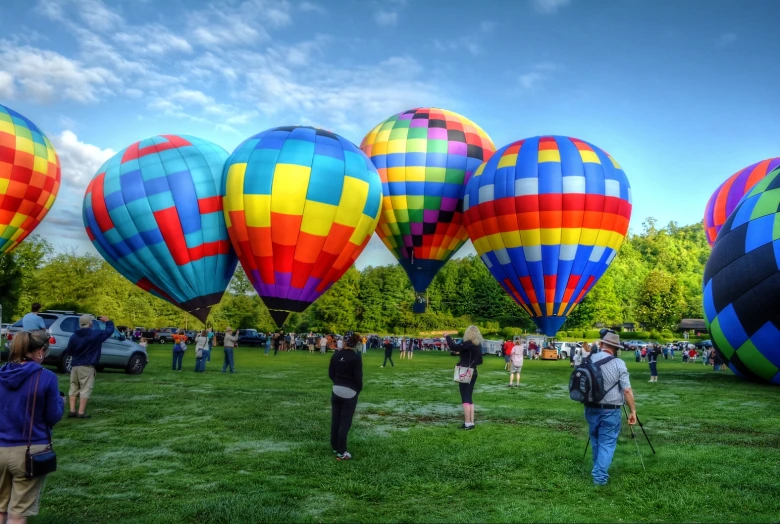 several large and small  air balloons being flown in the sky