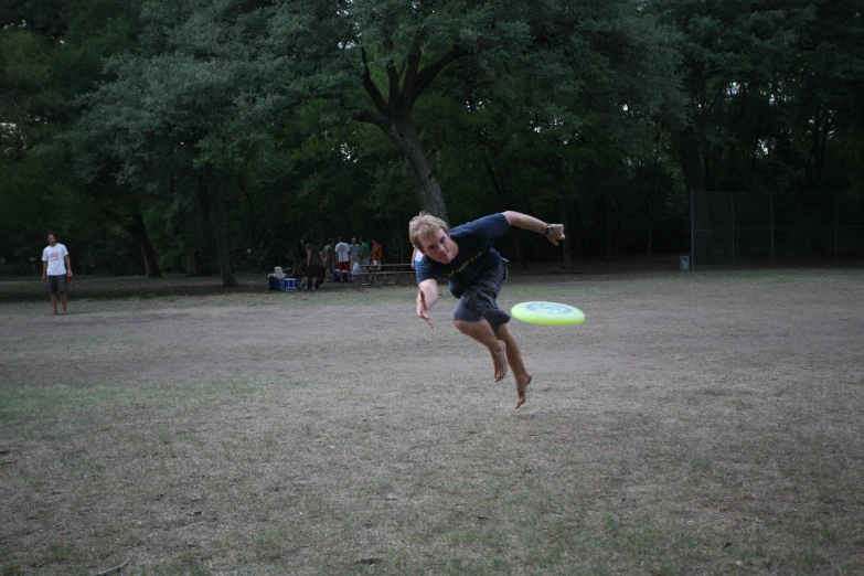 a man playing with a frisbee in a large open field
